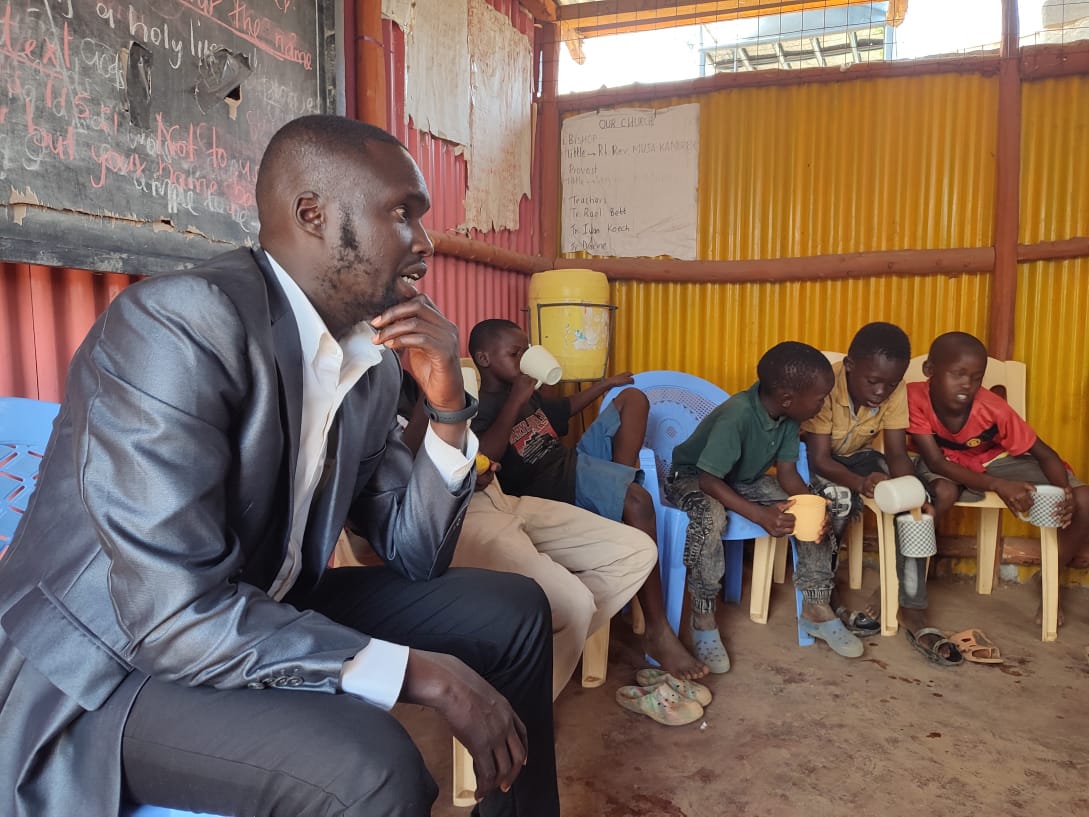 Geoffrey visiting school with children
